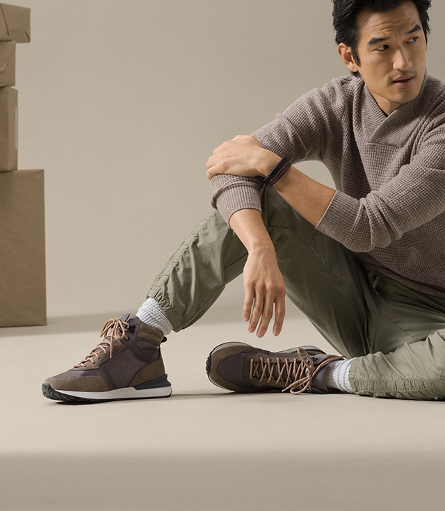 Male model styled in mauve turtleneck and olive cargo pants wearing the Baker fashion sneaker boot in Grey.