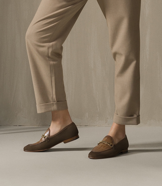 A woman poses in tan pants and Magnanni Carmen loafers. 