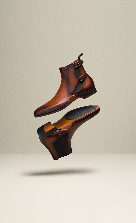 Magnanni Grant boots in cognac float in mid-air.