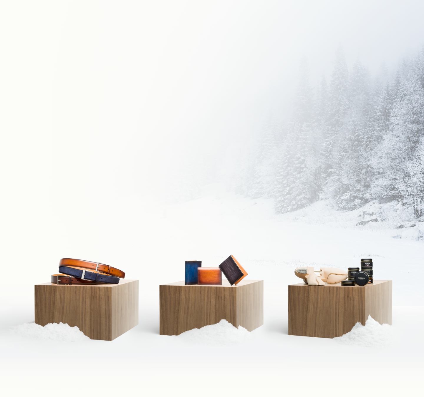 Magnanni accessories sit on wooden platforms in a snowy environment.
